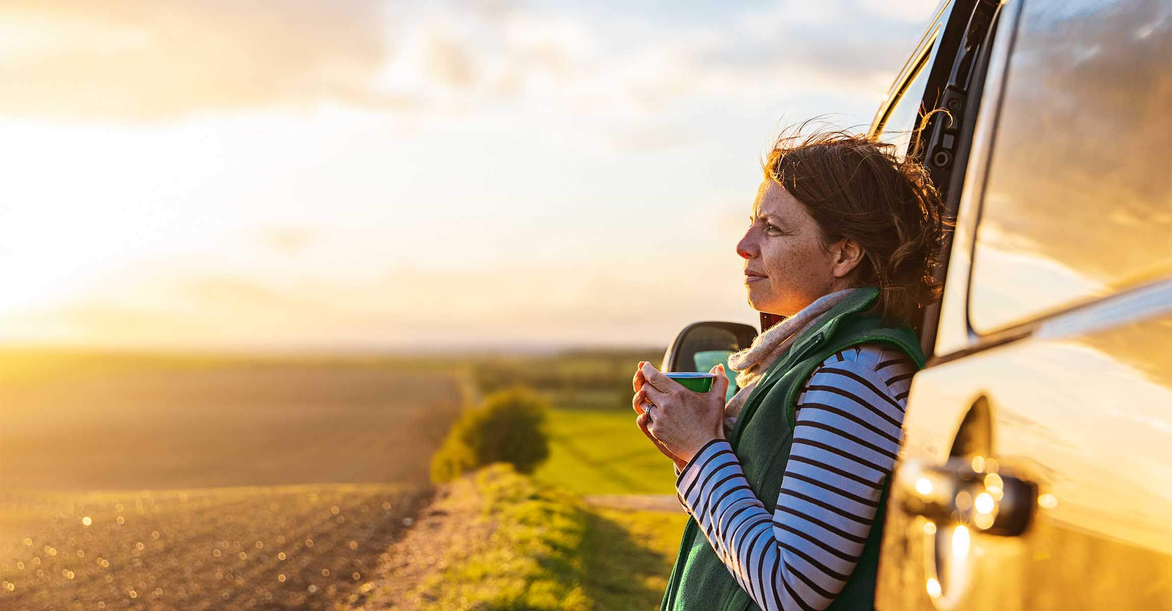 woman next to van with tea