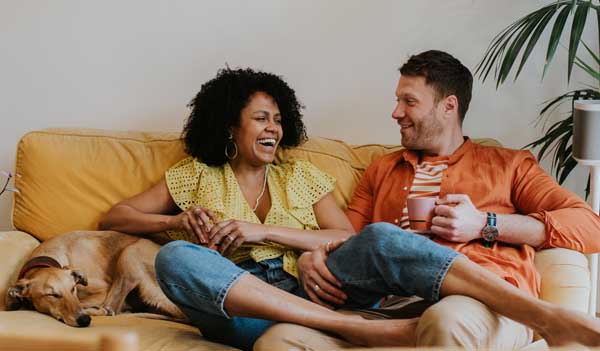 Couple laughing on sofa