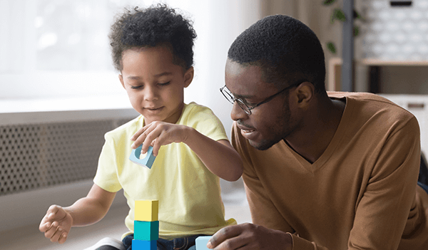 Man and son building block tower