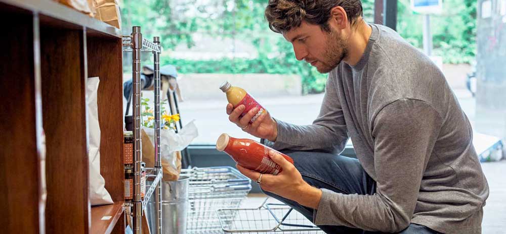 man looking at drinks