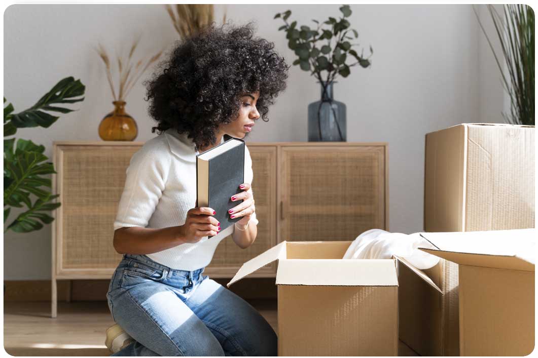 Woman with boxes holding book