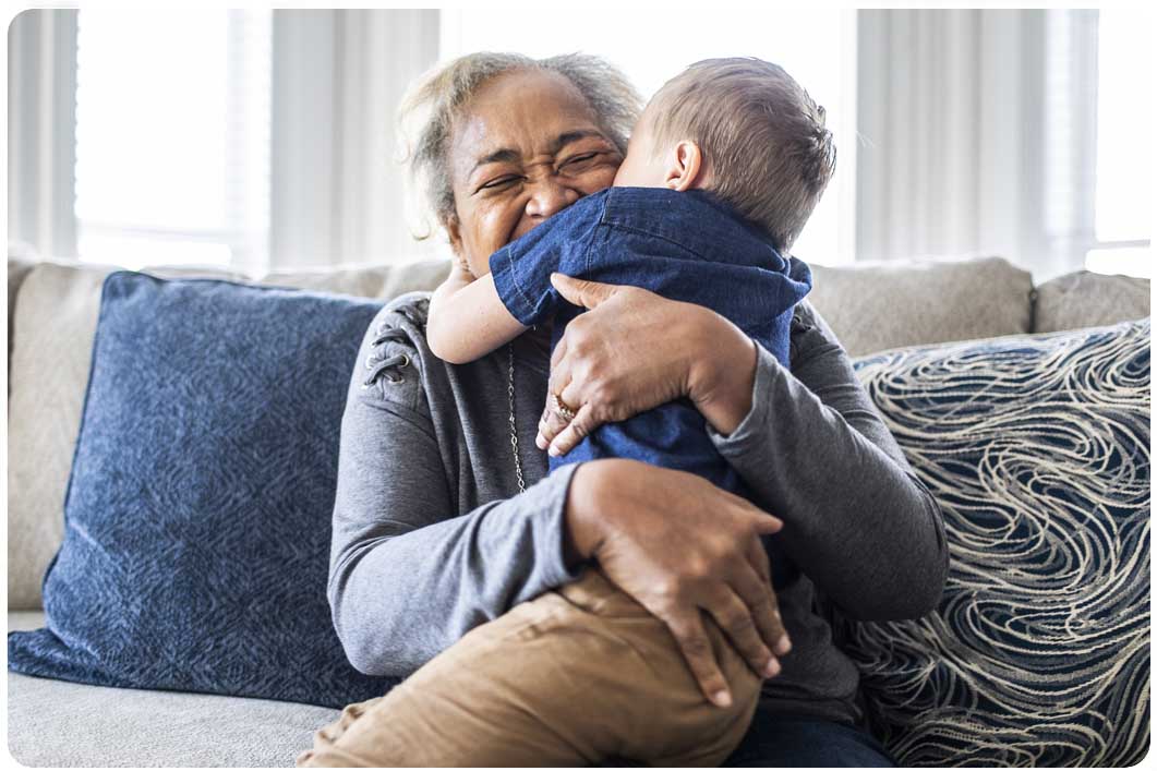 Grandparent cuddling grandchild