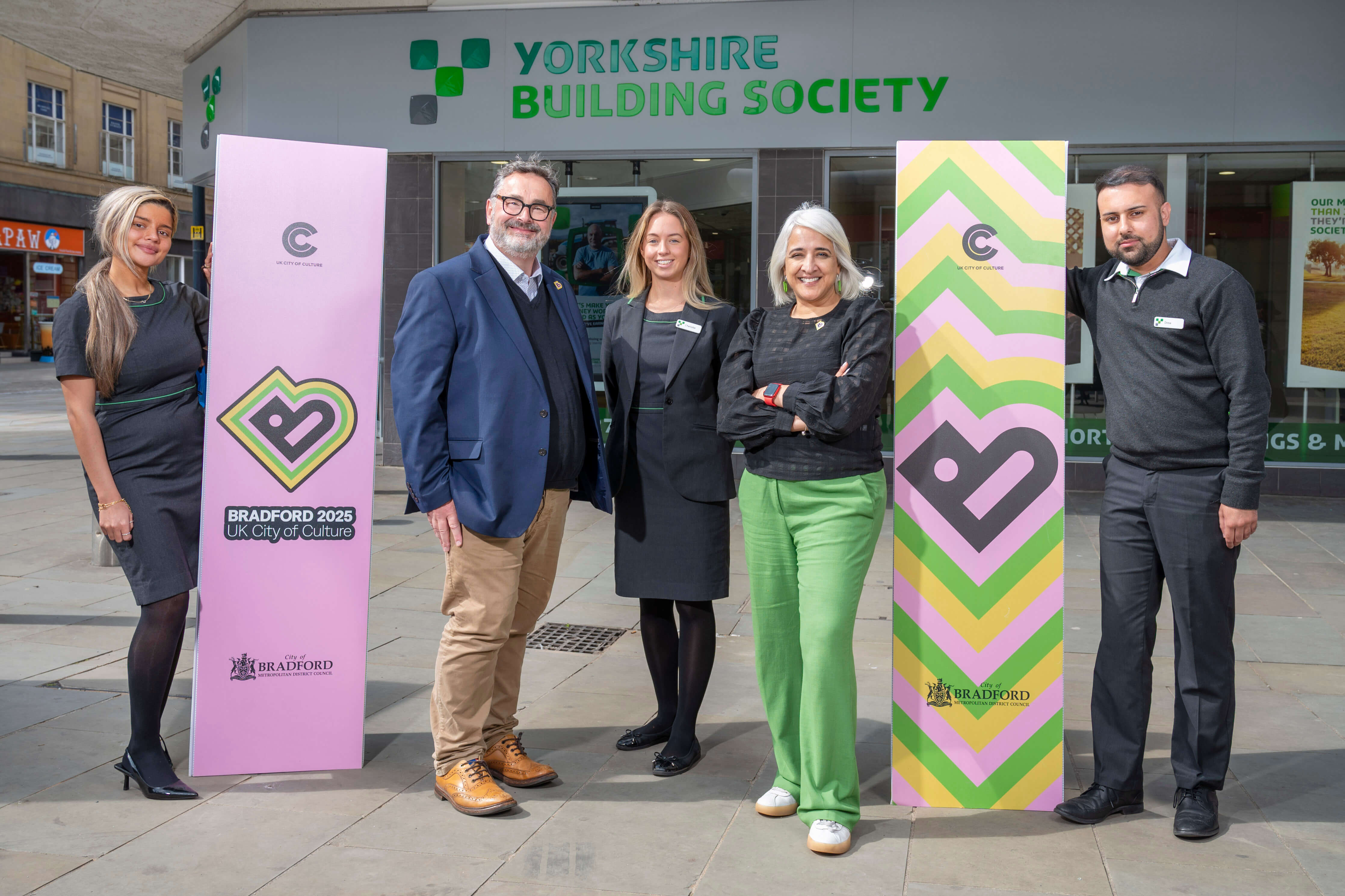 Bradford 2025 Executive Director Dan Bates and Creative Director Shanaz Gulzar with colleagues from Yorkshire Building Society's Bradford branch 